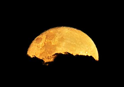 Full moon behind cloud